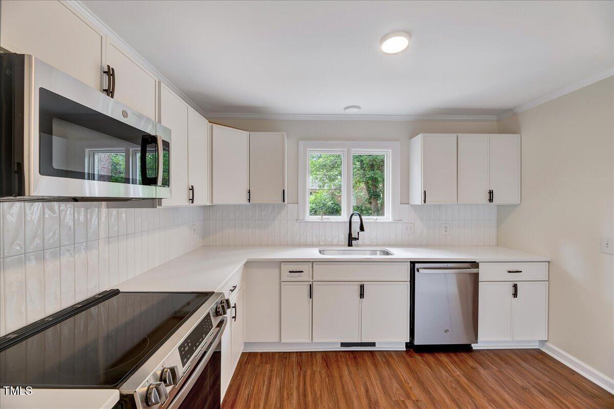 2585 Cabin Branch Road Kinston, NC 28504 - Photo 6 of 42 a kitchen with a sink stove and cabinets