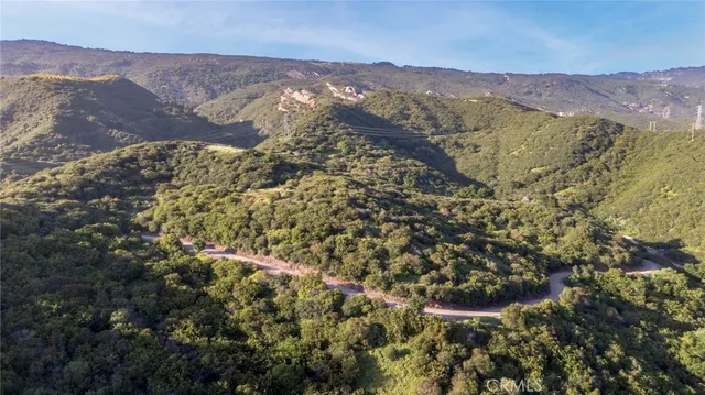 a view of a field with a mountain in the background