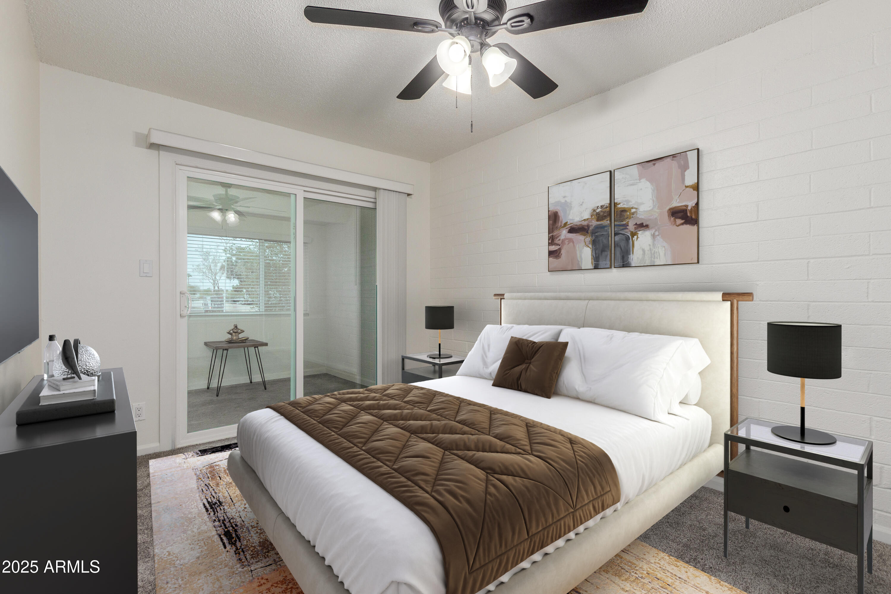 2608 West Berridge Lane, Unit C220 Phoenix, AZ 85017 - Photo 12 of 21 a bedroom with a bed and a chandelier