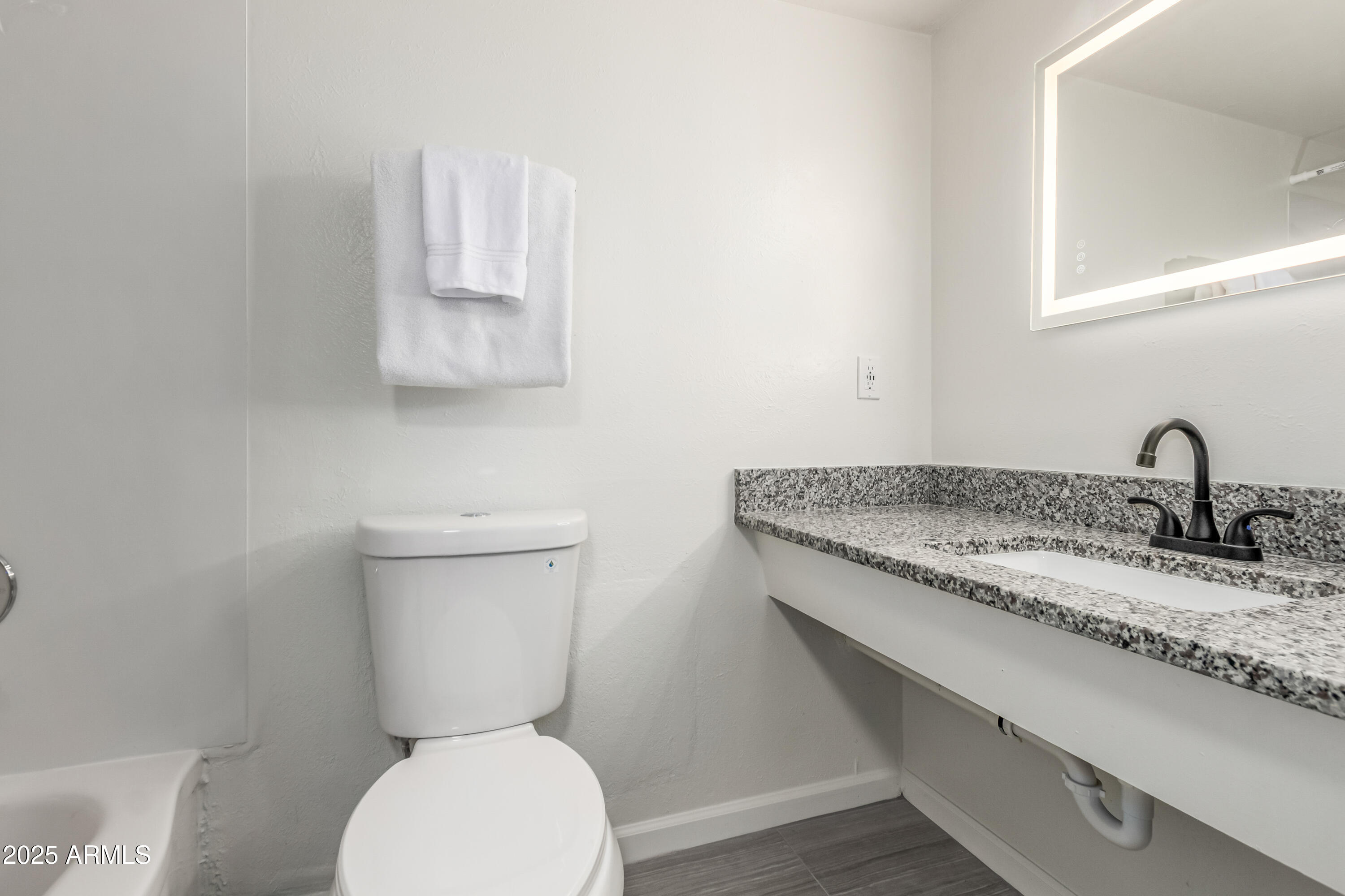 2608 West Berridge Lane, Unit C220 Phoenix, AZ 85017 - Photo 15 of 21 a bathroom with a granite countertop toilet and a sink