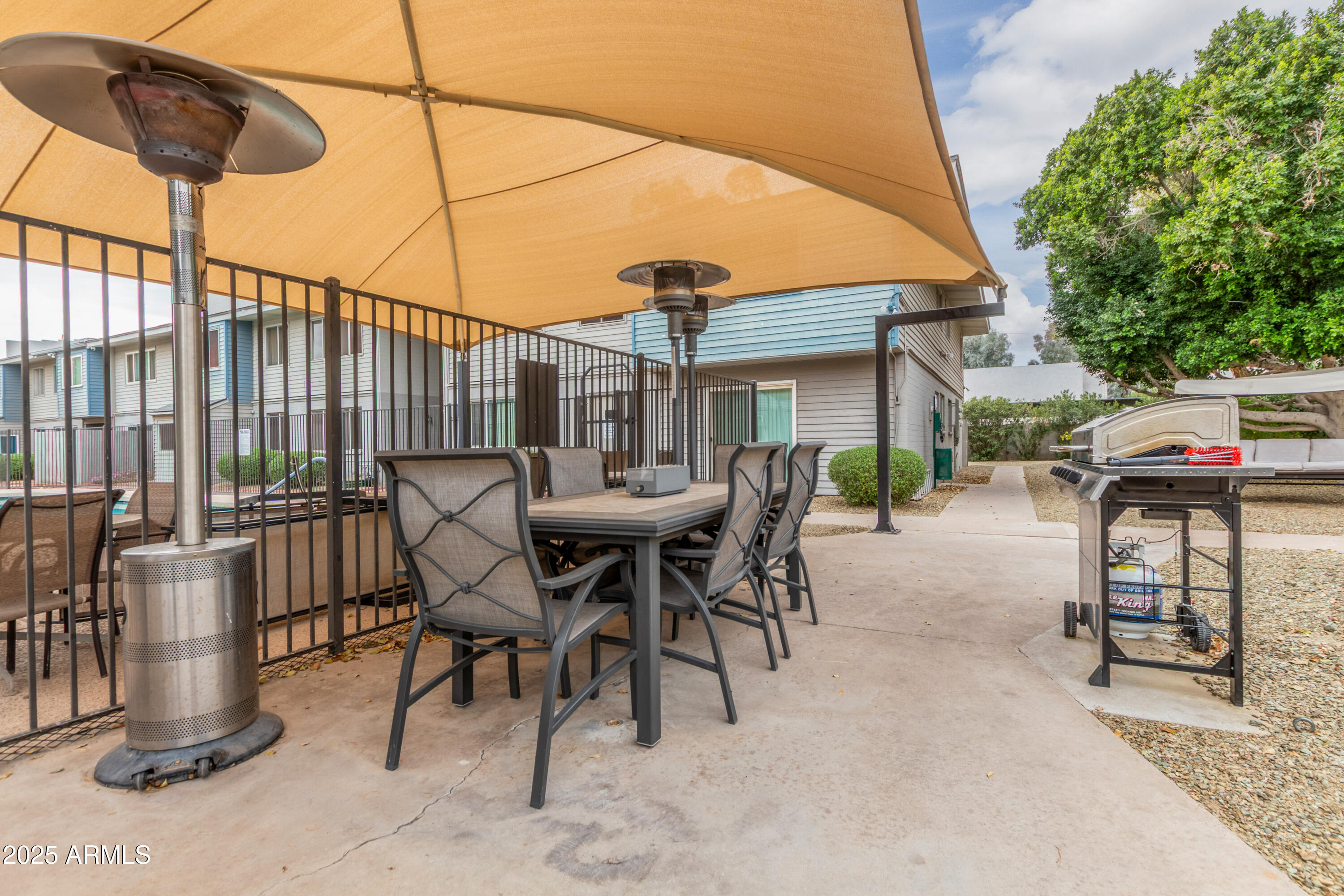 2608 West Berridge Lane, Unit C220 Phoenix, AZ 85017 - Photo 19 of 21 a view of a patio with a table and chairs