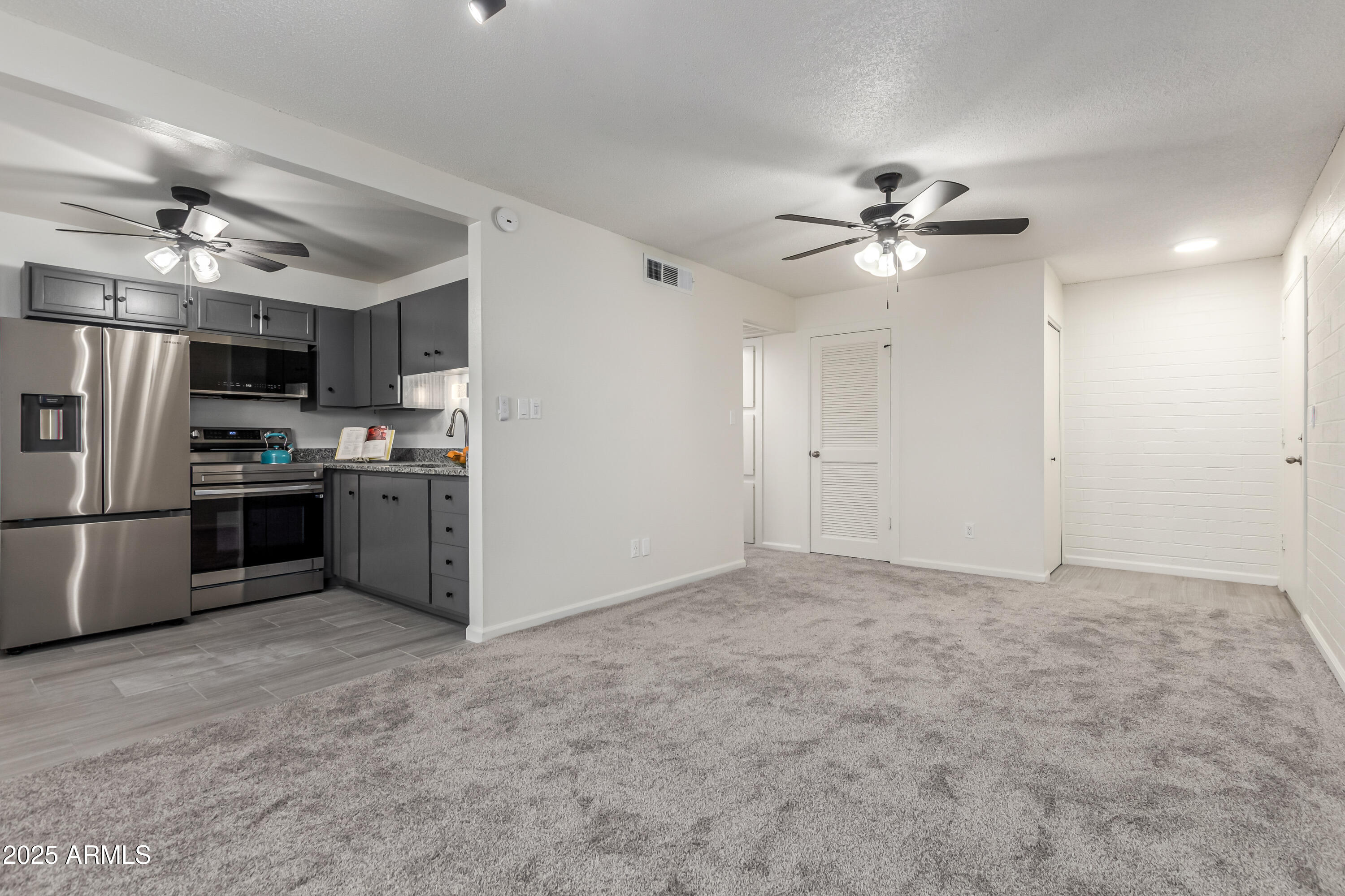 2608 West Berridge Lane, Unit C220 Phoenix, AZ 85017 - Photo 2 of 21 a view of a kitchen with a sink and stainless steel appliances