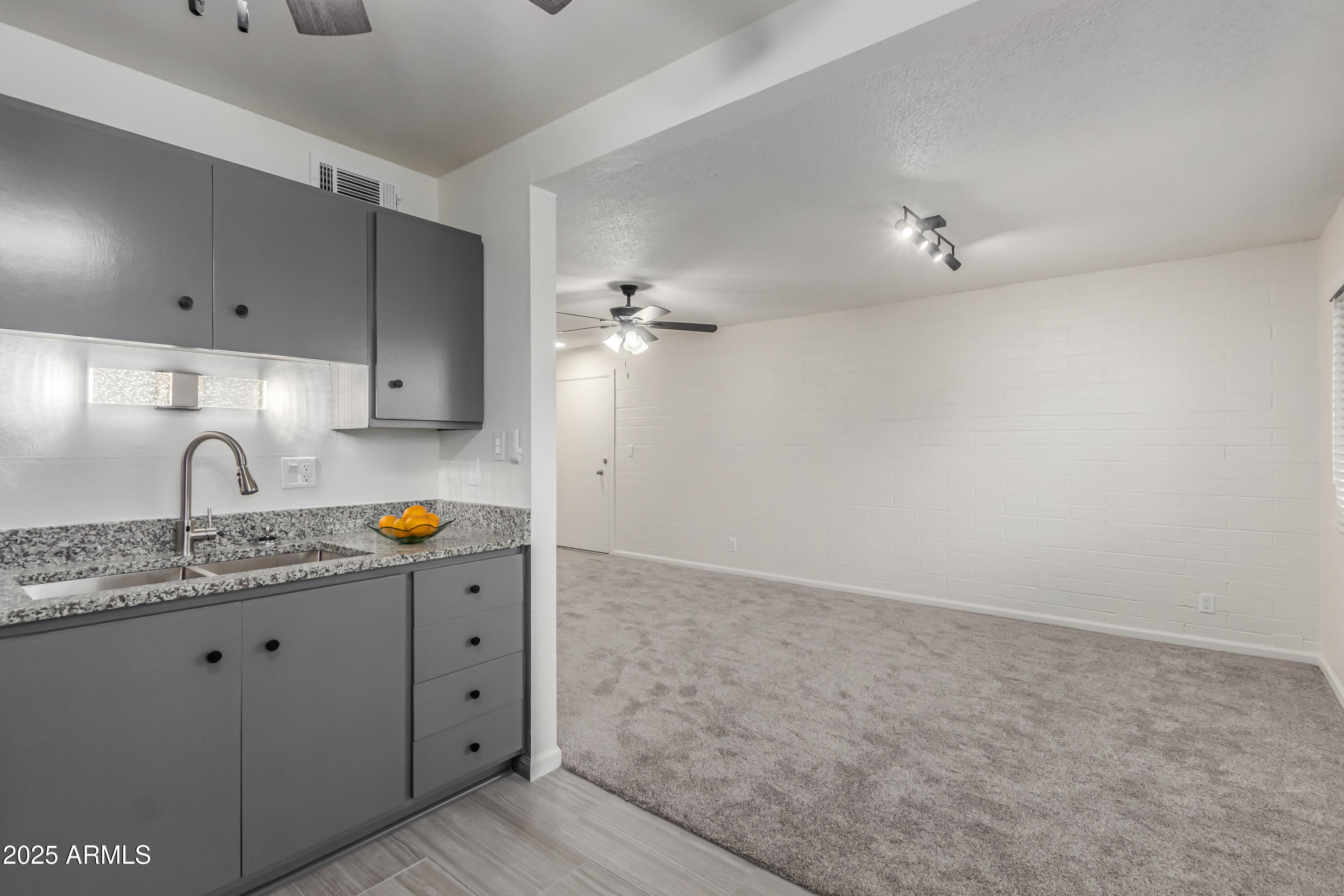 2608 West Berridge Lane, Unit C220 Phoenix, AZ 85017 - Photo 4 of 21 a kitchen with a sink cabinets and utility room