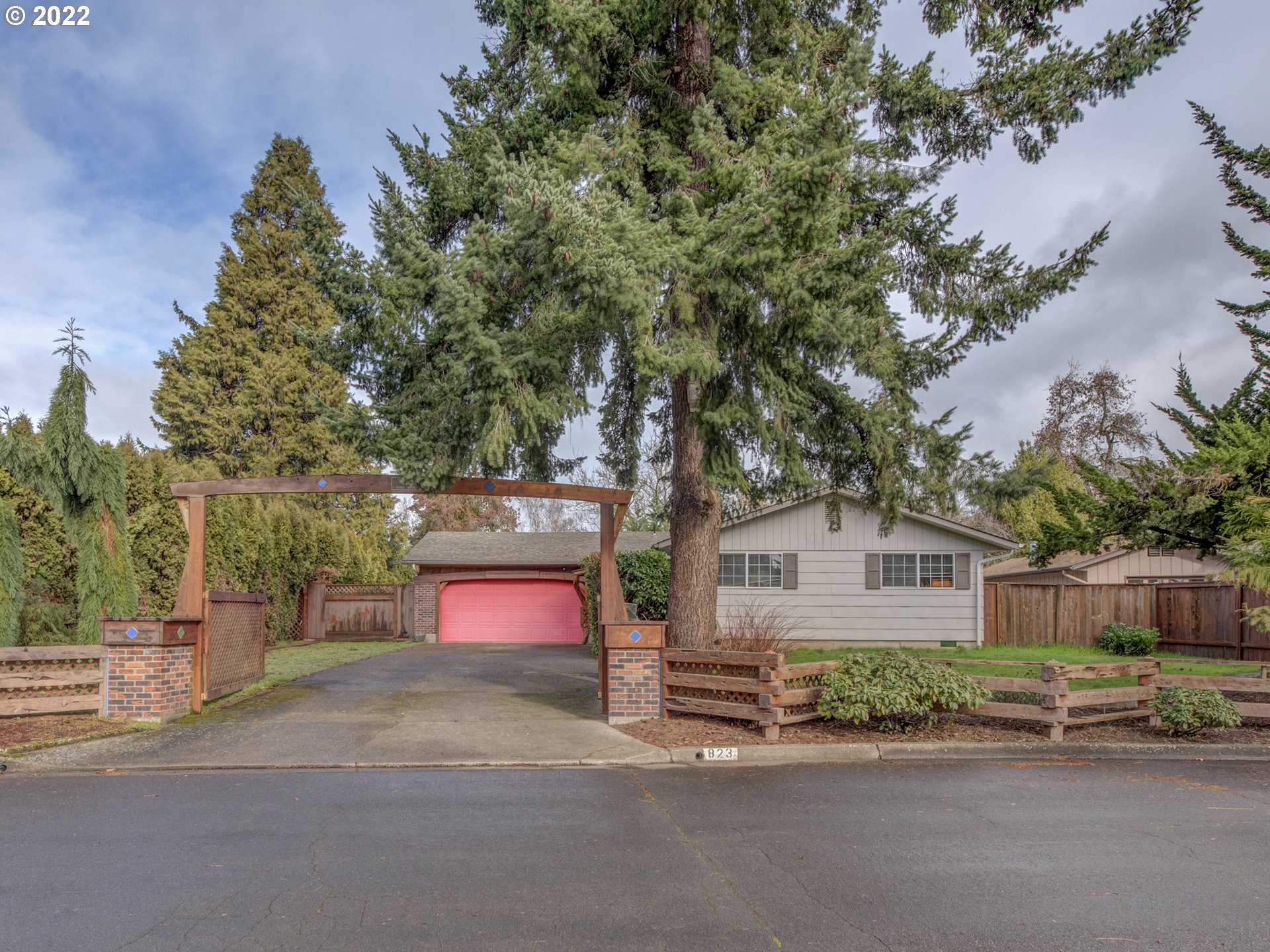 823 Rowan Avenue Springfield, OR 97477 - Photo 1 of 21 a flower plants with wooden fence