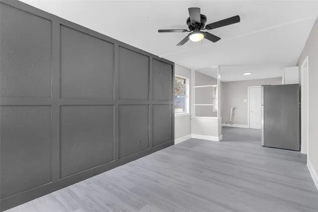 a view of an empty room with a ceiling fan