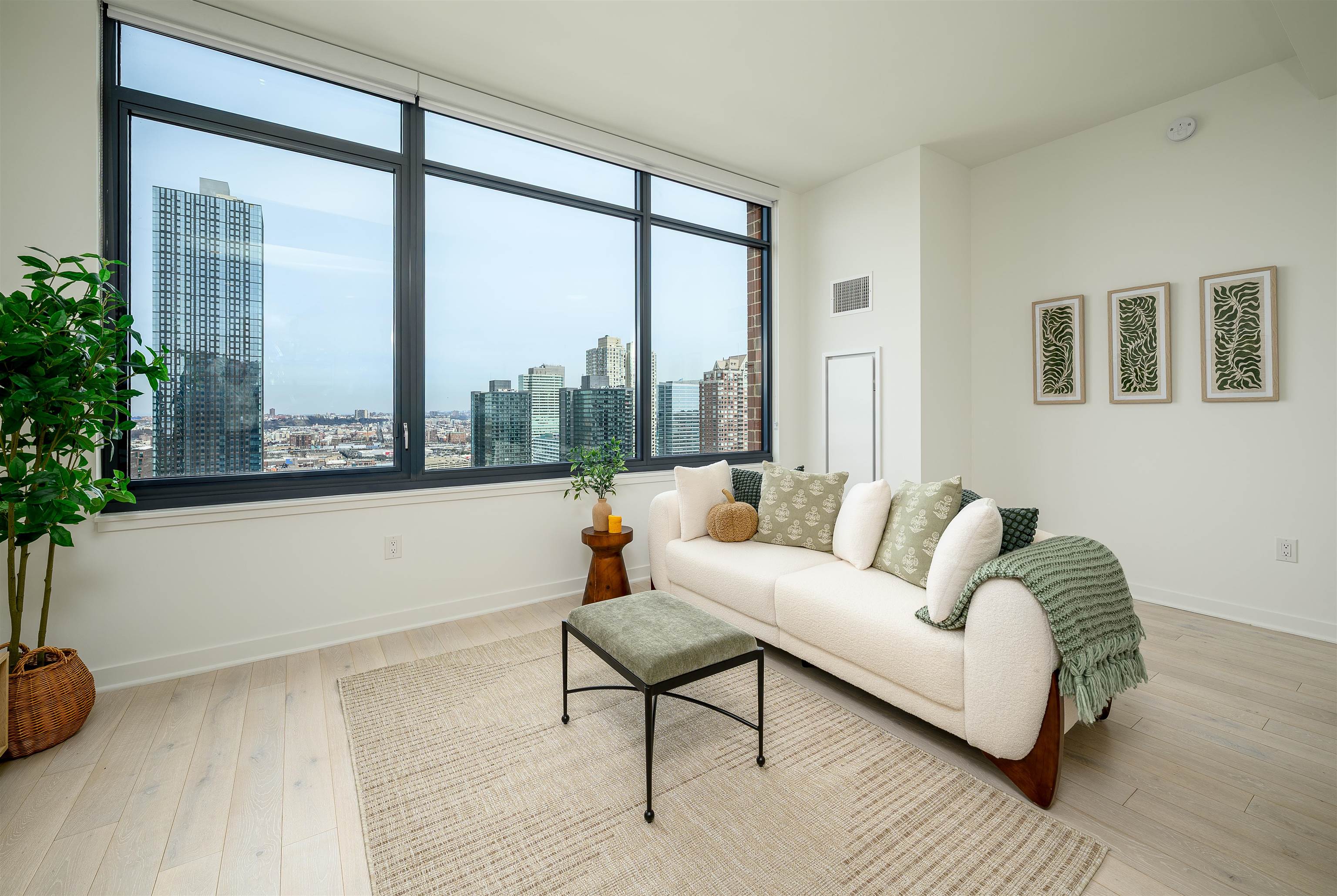 155 Bay Street, Unit R3102 Jersey City, NJ 07302 - Photo 5 of 21 a living room with furniture and a floor to ceiling window