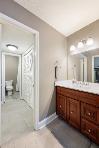 a spacious bathroom with a double vanity sink and a mirror