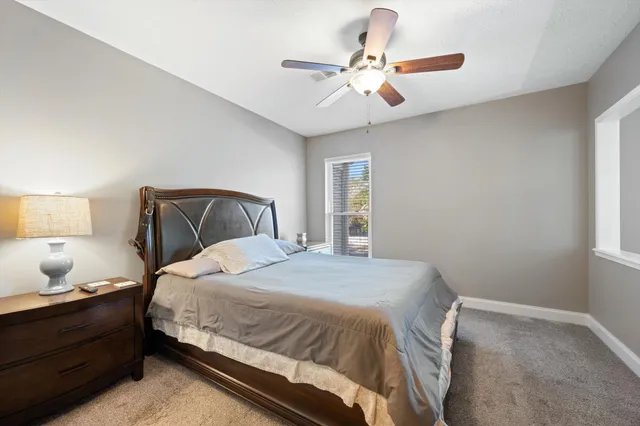 a bedroom with a bed and window