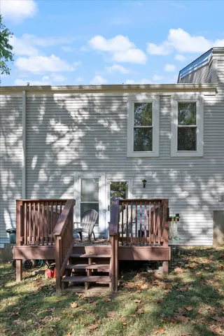 a view of a roof deck with table and chairs