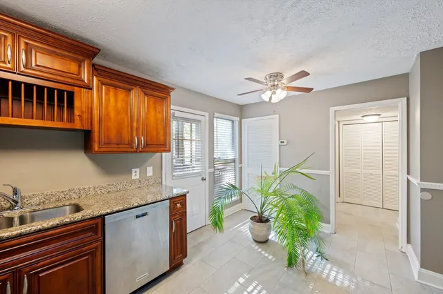 a kitchen with stainless steel appliances granite countertop a sink a stove and a granite counter top