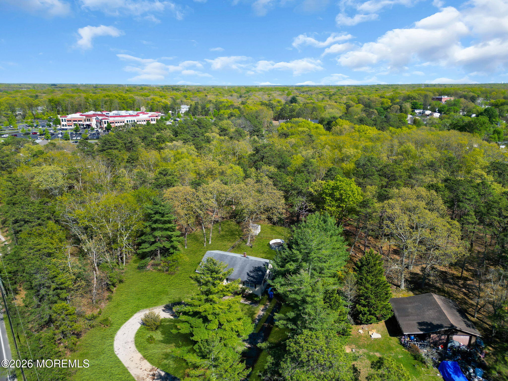 635 Bennetts Mills Road Jackson, NJ 08527 - Photo 9 of 18 a view of a lush green forest with a house in the background