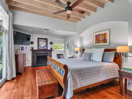 a bedroom with furniture and a flat screen tv