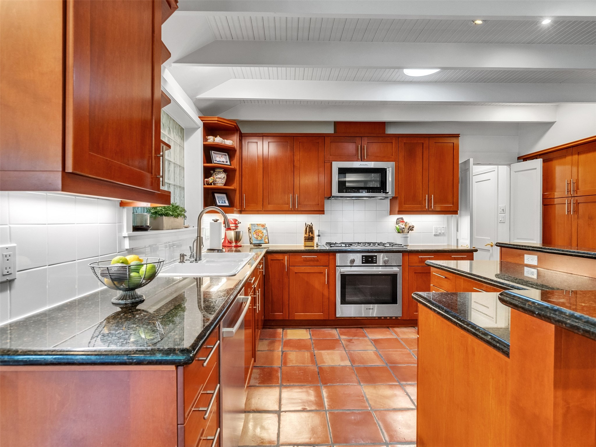 8202 Burkhart Road Houston, TX 77055 - Photo 18 of 29 This kitchen has granite counters, stainless appliances, gas range and a large pantry storage area.