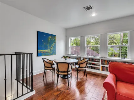 a living room with fireplace furniture and a wooden floor