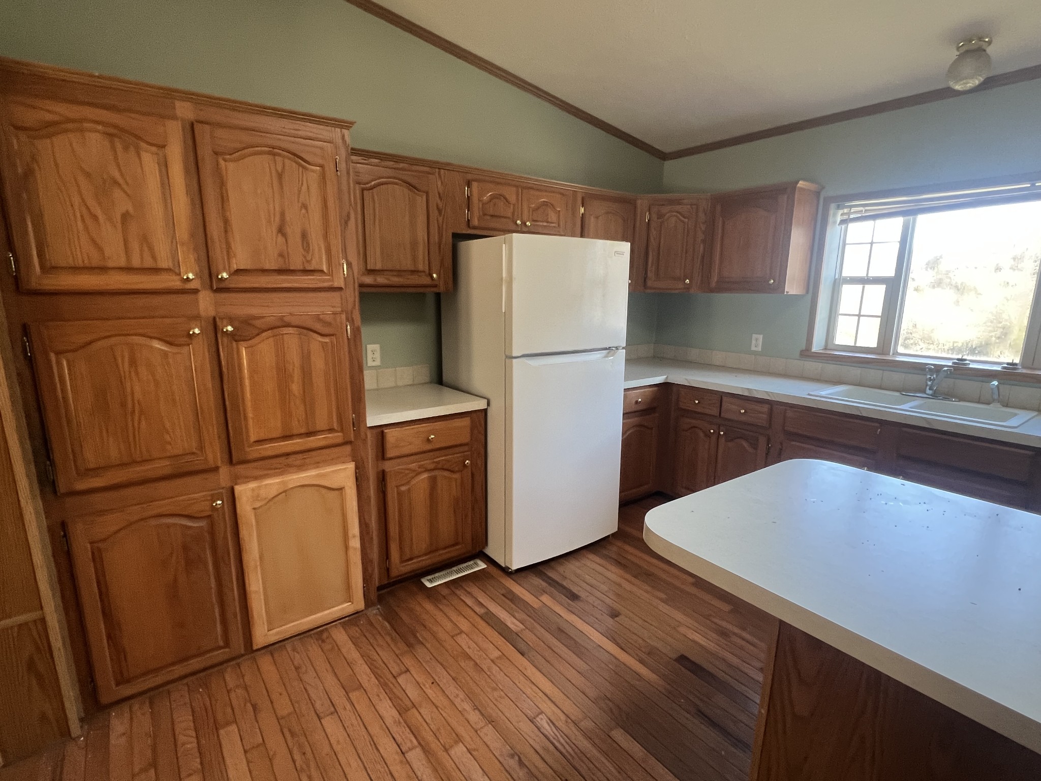 697 Club Springs Road Buffalo Valley, TN 38548 - Photo 8 of 29 a kitchen with wooden floors and white appliances