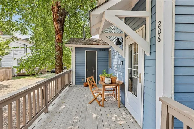 a balcony with chairs and wooden floor