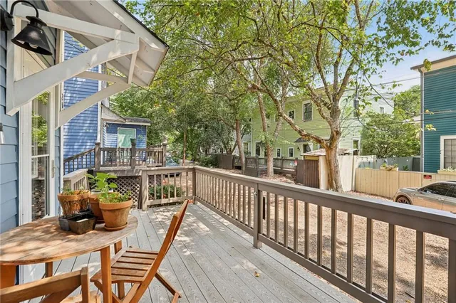 a view of a balcony with chair and wooden floor