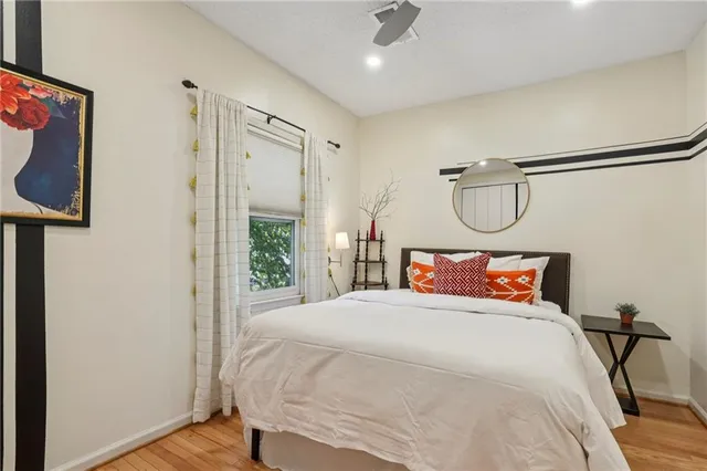a bedroom with a large bed and a chandelier