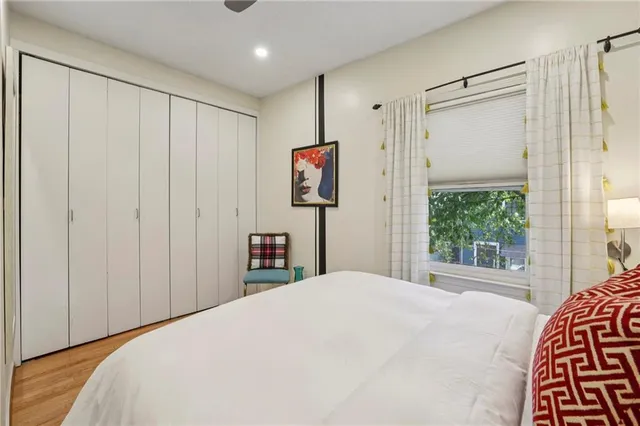 a bedroom with a bed and a window