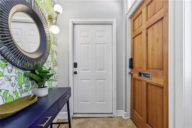 an entryway with a table and a mirror