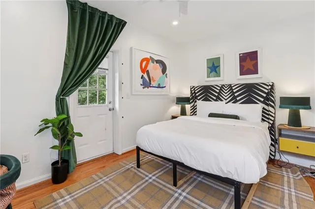 a bedroom with a bed and a potted plant