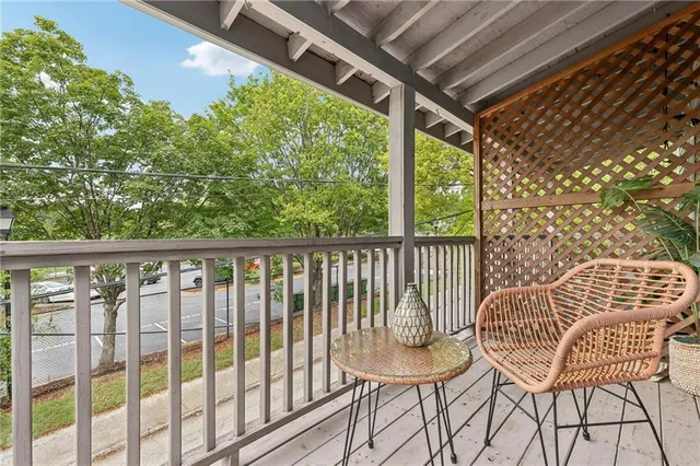 a view of a chair and tables in the balcony
