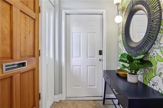 a dining room with furniture potted plants and wooden door