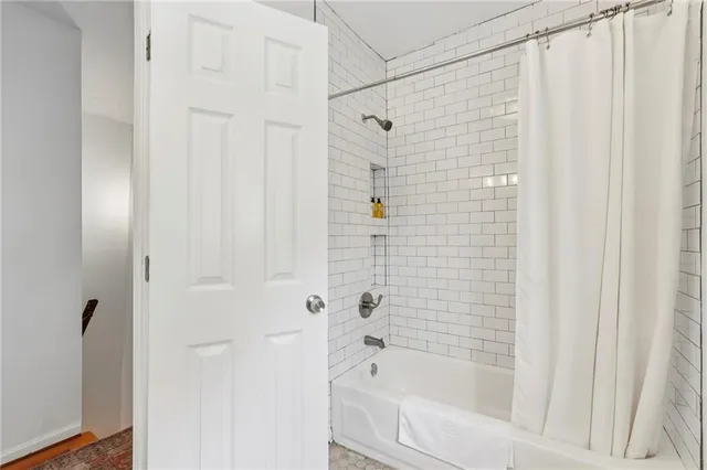 a bathroom with a shower and a bath tub