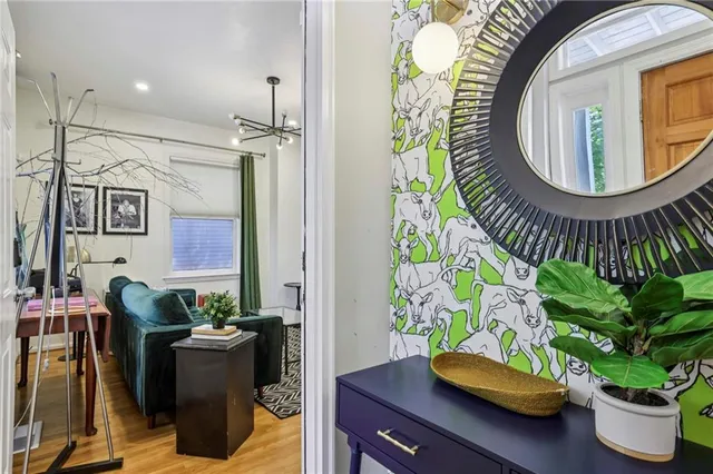 a living room with furniture and a potted plant