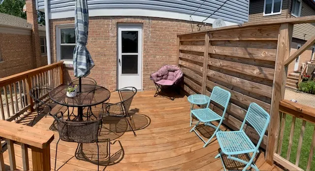 a view of a chairs and table in the balcony