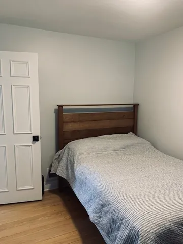 a bed sitting in a bedroom next to a cabinet