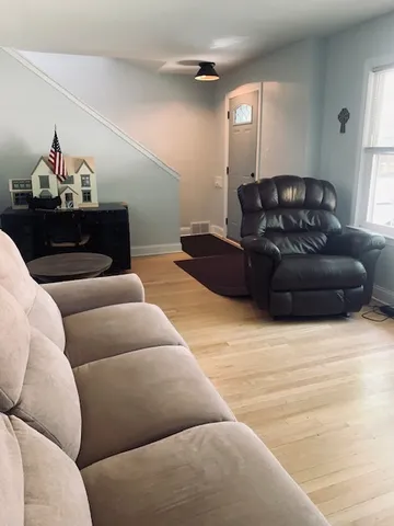 a living room with furniture and a lamp