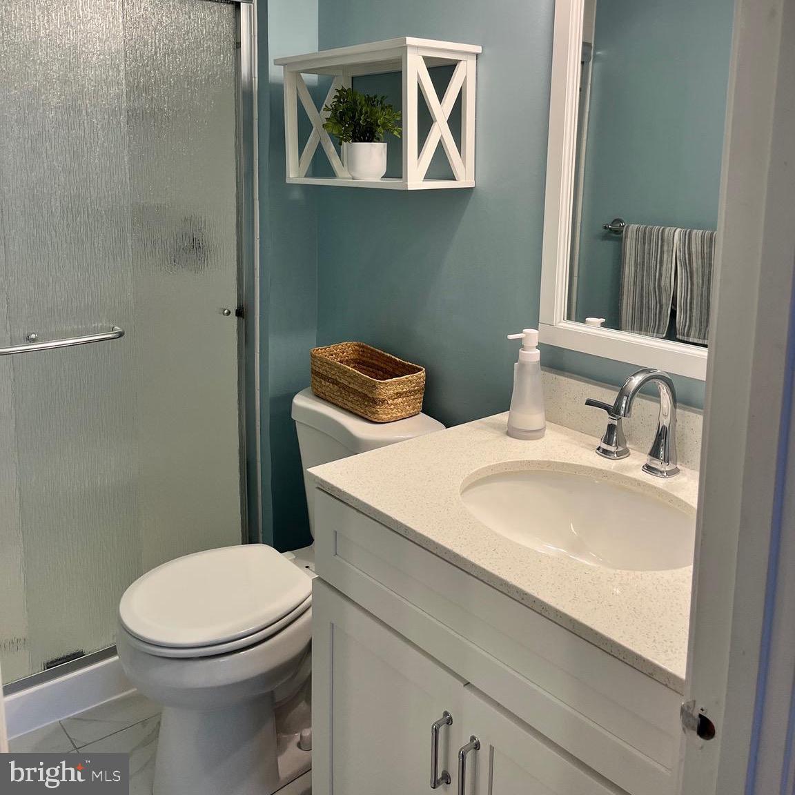 1815 Valley Glen Road, Unit 140 Elkins Park, PA 19027 - Photo 14 of 19 a bathroom with a sink a toilet and a mirror