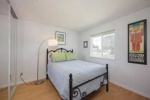 a bedroom with a bed and windows