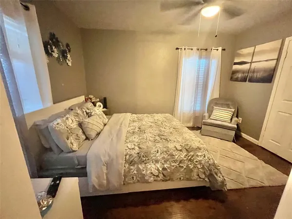 a bedroom with a bed and a mirror