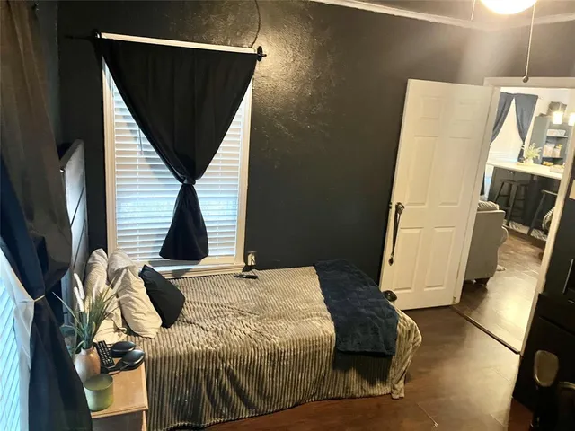 a bed sitting in a bedroom next to a window