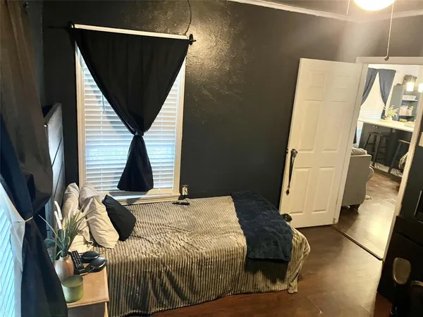 a bed sitting in a bedroom next to a window