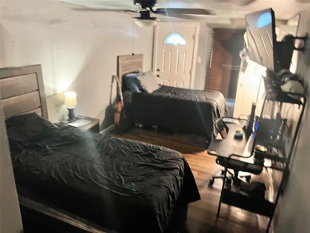 a bedroom with a bed and wooden floor