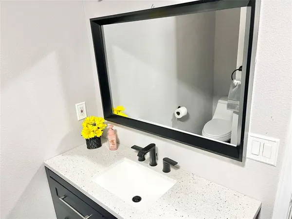 a bathroom with a sink and vanity
