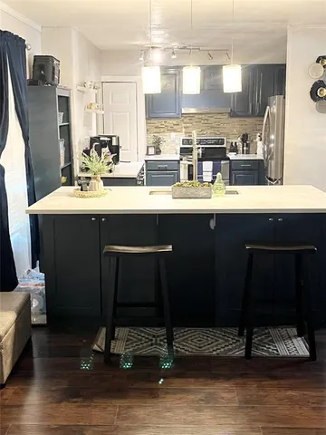 a kitchen with a sink cabinets and wooden floor