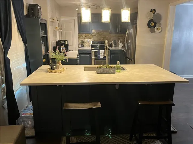 a bathroom with a sink vanity and a mirror