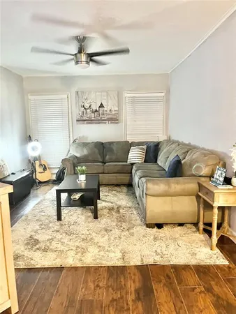 a living room with furniture and a rug