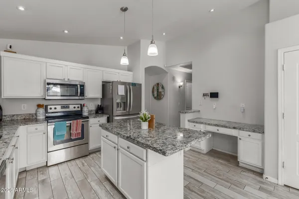 a kitchen with a stove a sink and a microwave