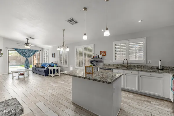 a kitchen with sink stove and living room