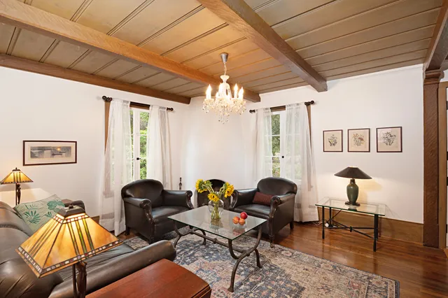 a living room with furniture and a chandelier