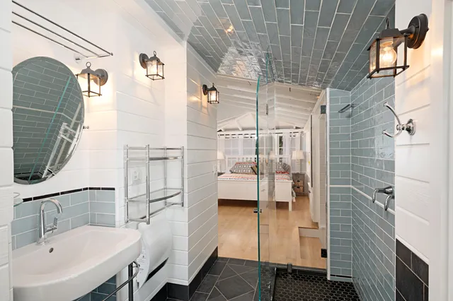 a bathroom with a sink a mirror and shower