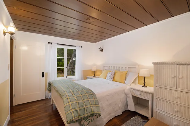 a bedroom with a large bed and a window