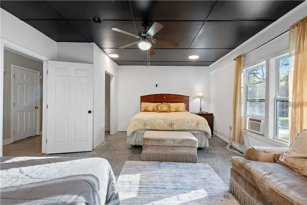 a bedroom with a large bed and a couch