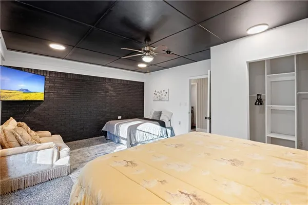 a bedroom with two beds and a chandelier