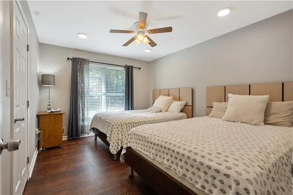 a bedroom with two large bed and a window